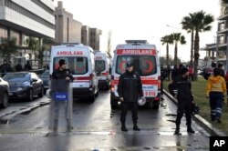 Security members and ambulances attend the explosion site in the Aegean city of Izmir, Turkey, Jan. 5, 2017.