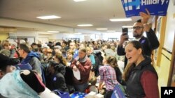 Hillary Clinton volunteers work the crowd for their candidate at the Democratic party caucus in Anchorage, Alaska, March 26, 2016.