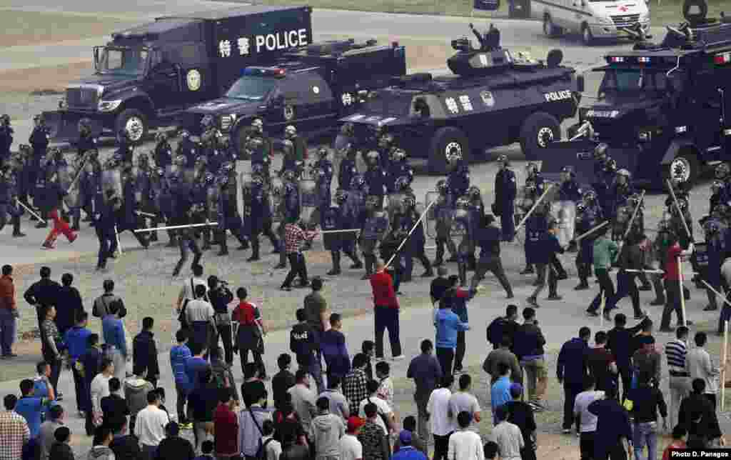 Police take part in a drill in preparation for dealing with mass disturbances in Beijing, China.