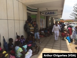 Zimbabweans looking for cash at a local bank.