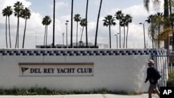 A man jogs past the Del Rey Yacht Club in California, where Jean and Scott Adams, two of the four Americans killed by Somali pirates, were members (File)