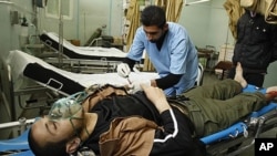 A wounded Palestinian man lies in Al-Najar hospital after an Israeli air strike in Rafah in the southern Gaza Strip, April 8, 2011