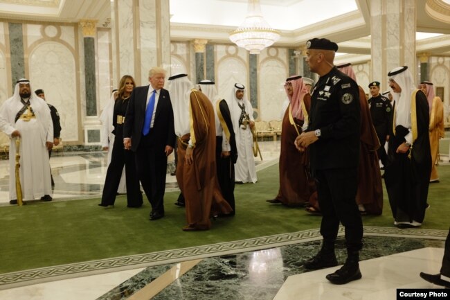 President Donald Trump and first lady Melania Trump walk with Saudi King Salman at the Royal Court Palace in Riyadh, Saturday, May 20, 2017.
