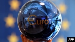 FILE - A person adjusts an EU decoration ball at the European Commission delegation building in Sofia, Bulgaria.