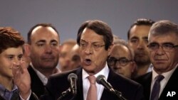 Cyprus President Nicos Anastasiades, center, speaks to supporters who gathered at a stadium to attend his inauguration ceremony in Nicosia, Sunday, Feb. 4, 2018. 
