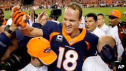 FILE - Peyton Manning celebrates his 509th career touchdown in Denver, Oct. 19, 2014. A Dec. 27, 2015, investigative documentary alleges Manning used performance-enhancing drugs. He denies the claims.