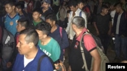 Central Americans are seen in the town of Tantima, Mexico, after Mexican authorities said that they rescued 147 Central Americans abandoned in the wilderness of Veracruz state, in this handout photograph released by the Mexican National Institute of Migration, July 30, 2017.