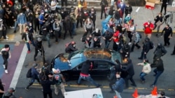 Dan Gregory appears to try and enter the vehicle of a man who tried to drive through the crowd during a protest against racial inequality in the aftermath of the death in Minneapolis police custody of George Floyd, in Seattle, Washington