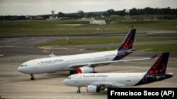 FILE - Two planes from Brussels Airlines are shown in this file photo on one of the routes for planes at Brussels Airport in Brussels on May 12, 2020. (AP Photo/Francisco Seco, File)