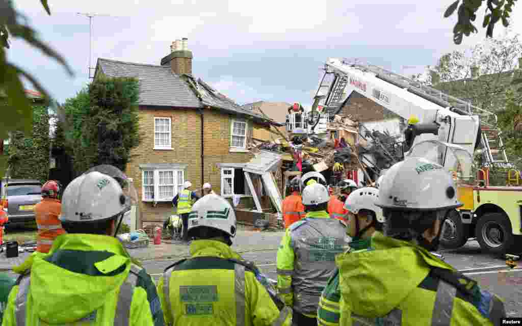 Emergency services work at the scene of a fallen tree at Bath Road in Hounslow, west London, Oct. 28, 2013. 