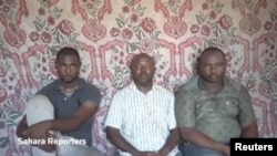 A still image taken from a video released by suspected Boko Haram militants on July 29, 2017, shows three kidnapped members of an oil exploration team in northeastern Nigeria. 