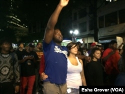 Protesters are out for the fourth night in Charlotte, marching through the uptown area, as helicopters continue to circle above, in Charlotte, North Carolina. Demonstrators are protesting a police shooting that killed an African-American man on Tuesday.