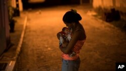 Daniele Ferreira dos Santos holds her son Juan Pedro, who was born with microcephaly, outside her house in Brazil. Santos was never diagnosed with Zika, but she blames the virus for her son’s defect