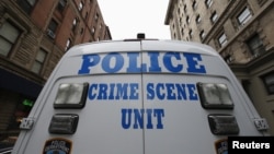 FILE - A New York City Police Crime Scene Unit vehicle stands outside an apartment building on New York City's upper west side of Manhattan.