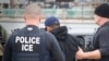 FILE - U.S. Immigration and Customs Enforcement (ICE) agents arrest foreign nationals, Feb. 7, 2017, in Los Angeles. Under the Trump administration, ICE has been directed to pursue deportations aggressively, with a particularly strong focus on Cambodians.