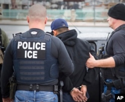 FILE - U.S. Immigration and Customs Enforcement (ICE) agents arrest foreign nationals in Los Angeles, Feb. 7, 2017.