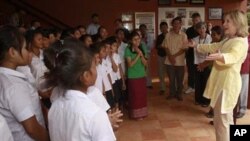 US Secretary of State Hillary Rodham Clinton right talks with a group in a center during a visit to a shelter for victims of sexual exploitation in Cambodia.