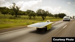 University of Michigan’s 2014 solar car, Quantum, speeds down the highway in the American Solar Challenge. (Darren Cheng)