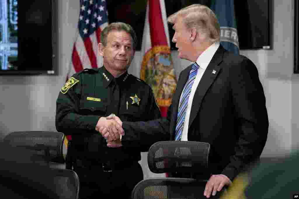 President Donald Trump shakes hands with Broward County Sheriff Scott Israel as he meets with law enforcement officers at Broward County Sheriff's Office in Pompano Beach, Fla., Feb. 16, 2018, following Wednesday's shooting at Marjory Stoneman Douglas Hig