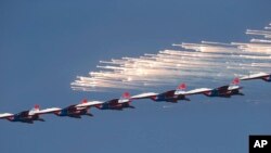MiG-29 jet fighters of Russian aerobatic team Strizhi (Swifts) perform during a ceremony in Batajnica, military airport near Belgrade, Oct. 20, 2017.