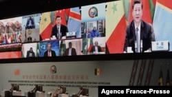 FILE - Chinese President Xi Jinping (on the screen) delivers his speech during the China-Africa Cooperation meeting in Dakar, Senegal, Nov. 29, 2021, when he pledged to offer 1 billion COVID-19 vaccine doses to Africa.