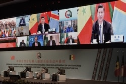 FILE - Chinese President Xi Jinping (on the screen) delivers his speech during the China-Africa Cooperation (FOCAC) meeting in Dakar, Senegal, Nov. 29, 2021.