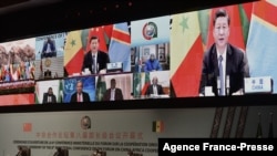 Chinese President Xi Jinping (on the screen) delivers his speech during the China-Africa Cooperation (FOCAC) meeting in Dakar, Senegal, Nov. 29, 2021. 