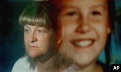 Maureen Kanka is reflected in a September 1993 photograph of her daughter, Megan, July 22, 2004. She takes comfort knowing her daughter will be forever remembered through "Megan's Law," now in effect in all 50 states.