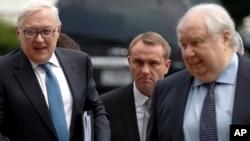 FILE - Russian Deputy Foreign Minister Sergei Ryabkov, left, and then-Russian Ambassador to the U.S. Sergey Kislyak, arrive at the State Department in Washington, July 17, 2017, for talks with Undersecretary of State Thomas Shannon. 