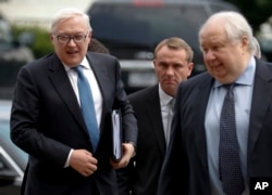 Russian Deputy Foreign Minister Sergei Ryabkov, left, and Russian Ambassador to the U.S. Sergey Kislyak, right, arrive at the State Department in Washington, July 17, 2017, for talks with Undersecretary of State Thomas Shannon.