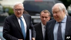 Russian Deputy Foreign Minister Sergei Ryabkov, left, and Russian Ambassador to the U.S. Sergey Kislyak, right, arrive at the State Department in Washington, July 17, 2017, for talks with Undersecretary of State Thomas Shannon. 