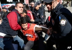 Turkish police officers arrest a demonstrator, during May Day protests in Istanbul, May 1, 2019.