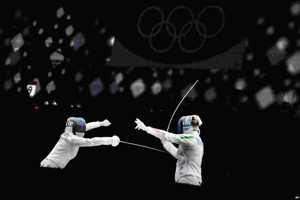 Mara Navarria of Italy, right, and Julia Beljajeva of Estonia compete in the women&#39;s individual epee team semifinal competition at the 2020 Summer Olympics, in Chiba, Japan. 