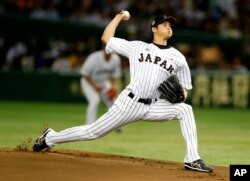 FILE - In this Nov. 19, 2015, file photo, Japan's starter Shohei Otani pitches against South Korea during the first inning of their semifinal game at the Premier12 world baseball tournament at Tokyo Dome in Tokyo.