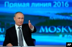 Russian President Vladimir Putin gestures as he answers a question during his annual call-in show in Moscow, April 14, 2016.