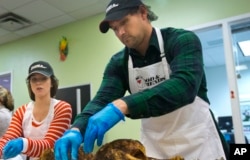 FILE - Washington Nationals baseball infielder Ryan Zimmerman, right, and his wife help pack turkeys for Thanksgiving meals in Washington, Nov. 23, 2015. Zimmerman has been accused of using performance-enhancing drugs, which he denies.