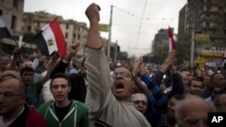 Egyptian protesters chant anti-Muslim Brotherhood slogans during a rally in front of the presidential palace, in Cairo, Egypt, Dec. 4, 2012.