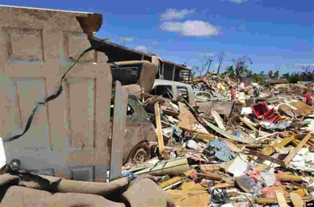 People look for their belongings in the Alberta City neighborhood Thursday April 28, 2011, after a tornado struck Tuscaloosa, Ala. the day before. Massive tornadoes tore a town-flattening streak across the South, killing at least 269 people in six states 