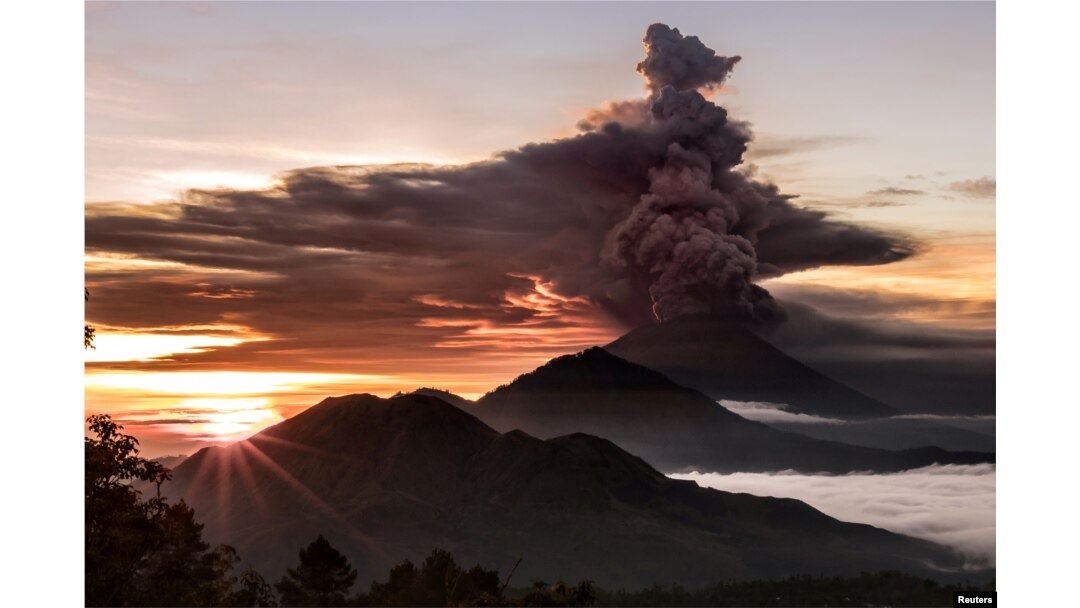 Mount Agung volcano is seen spewing smoke and ash in Bali, Indonesia, November 26, 2017 in this picture obtained from social media.