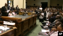 Zimbabwean Justice Minister Patrick Chinamasa, center, speaking in parliament about Zimbabwe's ballooning debt.
