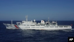 In this photo released by Japan's 11th Regional Coast Guard, a China Coast Guard vessel numbered 2506 sails in waters 66 kilometers (41 miles) from the East China Sea islands called Senkaku by Japan and Diaoyu by China Wednesday, July 24, 2013.