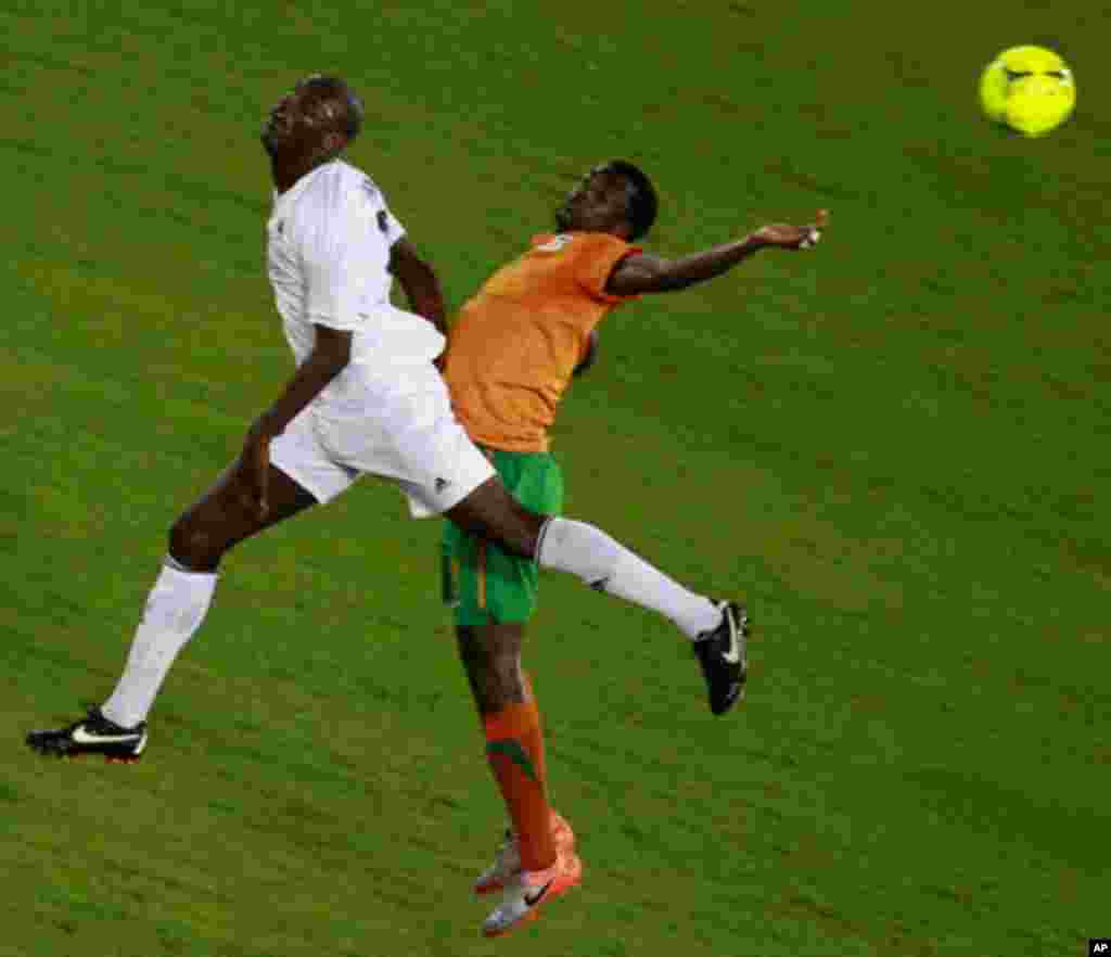 Francis Kasonde of Zambia challenges Djamal Mahamat of Libya during their African Nations Cup Group A soccer match at Estadio de Bata "Bata Stadium", in Bata