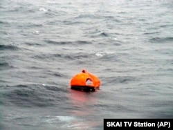 In this photo taken from a nearby boat showing a life raft from the Italian-flagged Norman Atlantic ferry after it caught fire in the Adriatic Sea, Dec. 28, 2014.