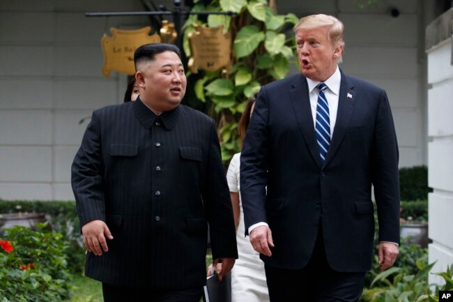 U.S. President Donald Trump and North Korean leader Kim Jong Un take a walk after their first meeting at the Sofitel Legend Metropole Hanoi hotel, Feb. 28, 2019, in Hanoi.