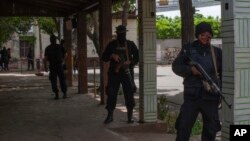 FILE - Heavily armed Nicaraguan police take their positions before the arrival of President Daniel Ortega, in Masaya, Nicaragua, July 13, 2018. According to human rights groups, some 270 people have been killed since April 19, when demonstrations against Ortega's government began.