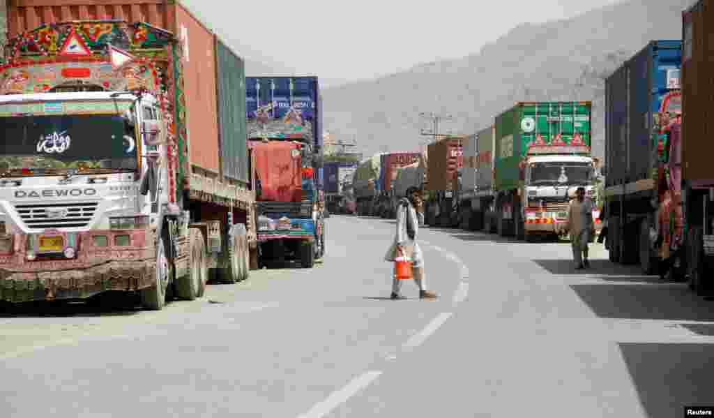 Transit trucks stranded due to the border skirmishes between Pakistan and Afghanistan are parked on the side of the road leading to the border in Torkham, Pakistan.