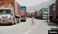 Transit trucks stranded due to the border skirmishes between Pakistan and Afghanistan are parked on the side of the road leading to the border in Torkham, Pakistan June 16, 2016.