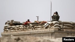 FILE - Fighters of the Syria Democratic Forces held a watchful position near Raqqa, Syria, May 27, 2016. 