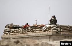 Fighters of the Syria Democratic Forces held a watchful position near Raqqa, Syria, May 27, 2016. U.S. officials believe the SDF is ready to at least start encircling the Islamic State stronghold, while planning for its liberation.