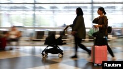 FILE - People arrive at Munich airport, in Munich, Germany, Aug. 3, 2017. Turkey is advising its citizens to avoid travel to Germany.